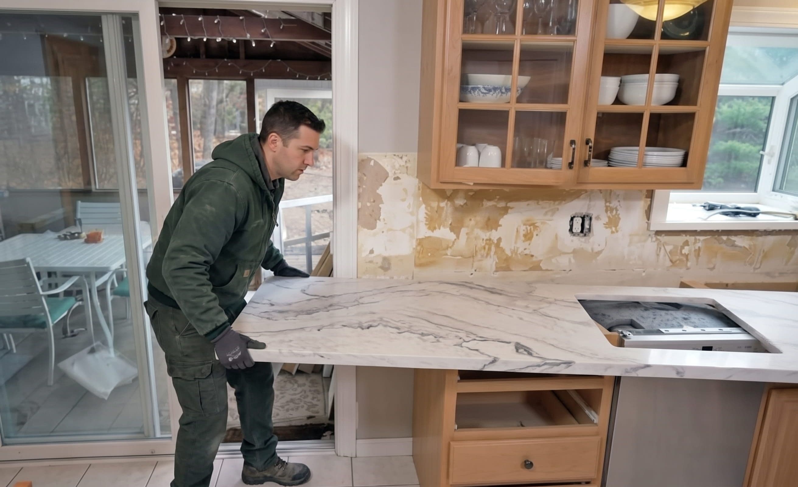 Installer positioning a stone countertop during a kitchen installation