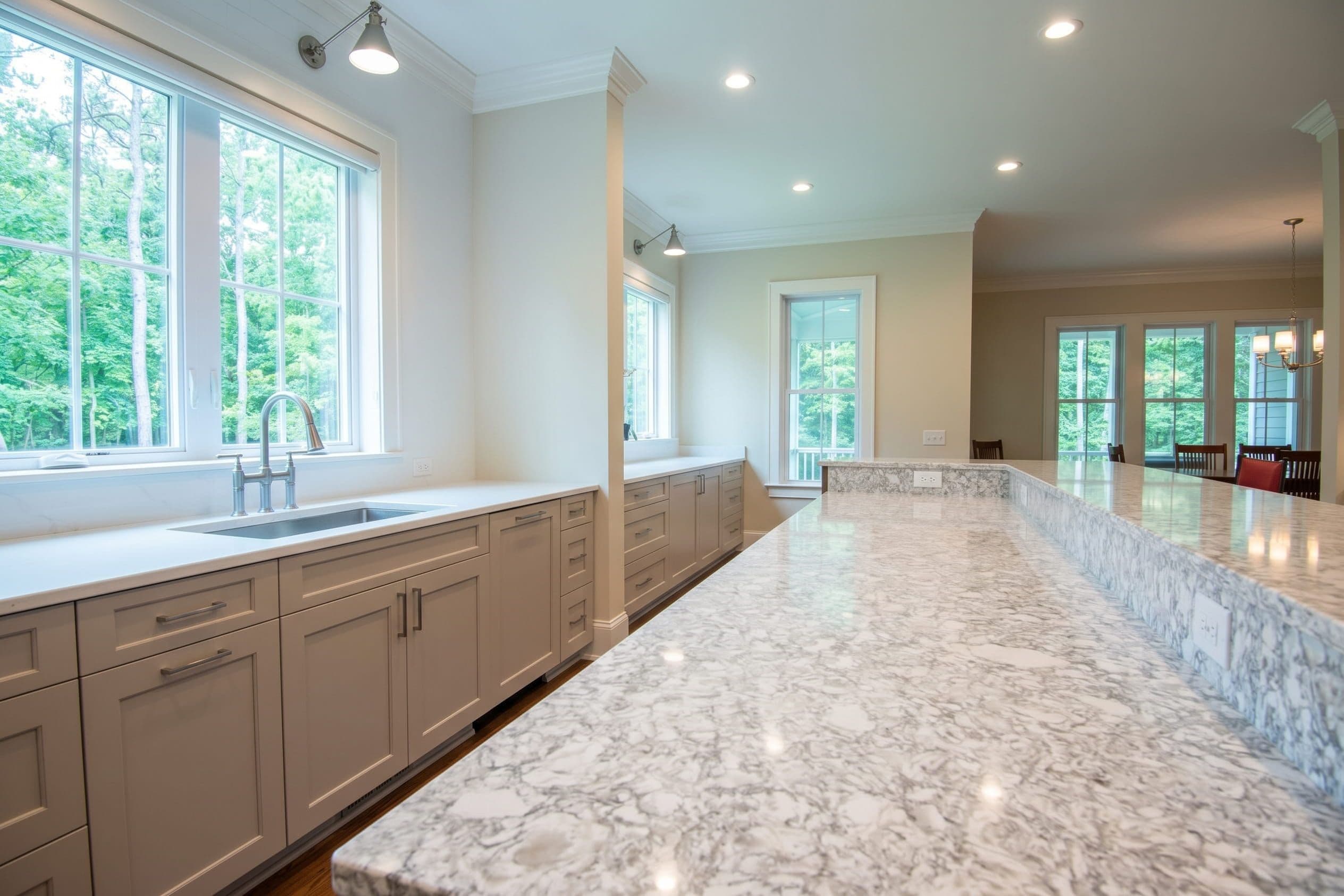 Installer positioning a stone countertop in a kitchen